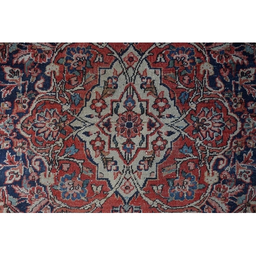 1074 - A pair of Persian rugs, having central floral medallions, with floral borders, with floral borders o... 