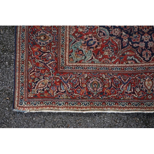 1074 - A pair of Persian rugs, having central floral medallions, with floral borders, with floral borders o... 