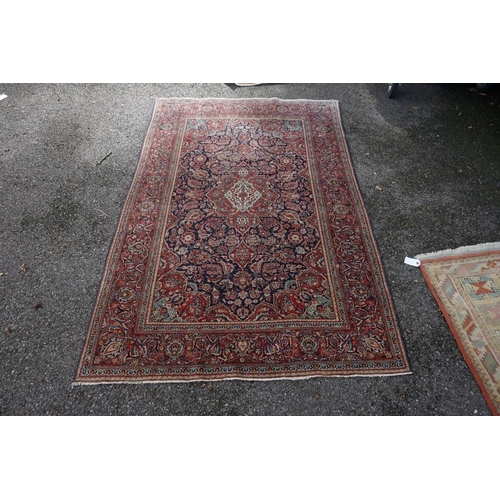 1074 - A pair of Persian rugs, having central floral medallions, with floral borders, with floral borders o... 