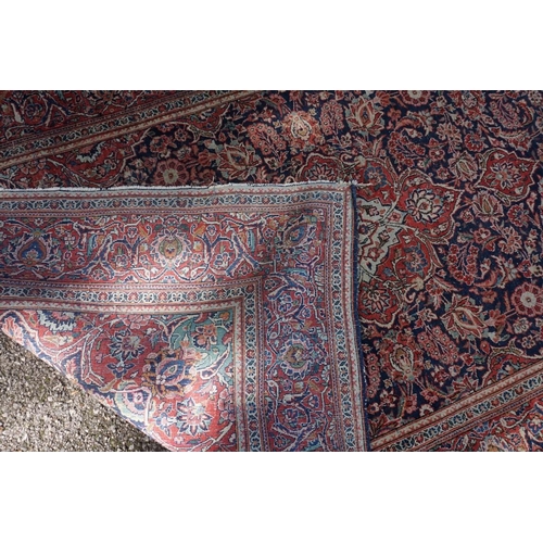 1074 - A pair of Persian rugs, having central floral medallions, with floral borders, with floral borders o... 