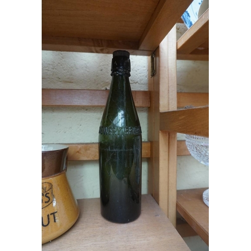 1103 - A mixed lot, to include a 'W & S Kemp Town Brewery, Brighton' green glass bottle, 27cm high; and... 