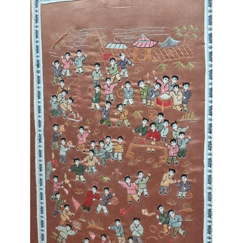 1142 - A Chinese silk 'hundred boys' panel, 65 x 32cm.