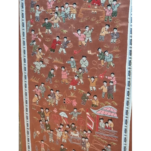 1142 - A Chinese silk 'hundred boys' panel, 65 x 32cm.