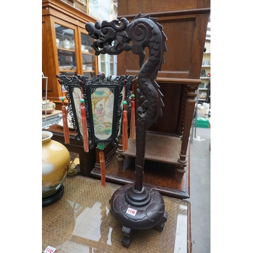 1146 - A Chinese carved wood table lamp, with hexagonal fabric shade, 69cm high.  ... 