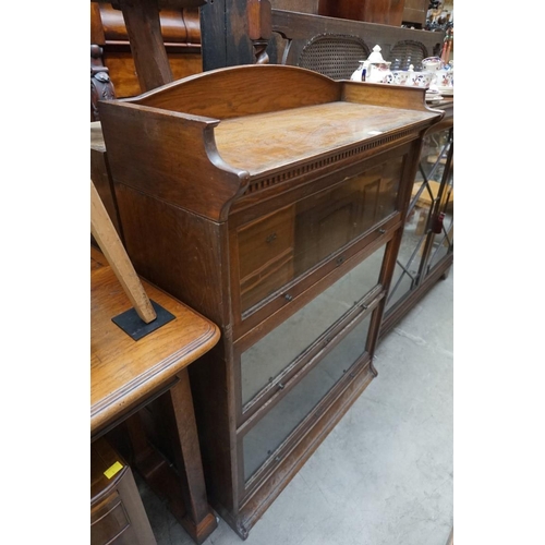 1153 - An early 20th century oak three tier sectional bookcase, by Lebus, 88cm wide. ... 