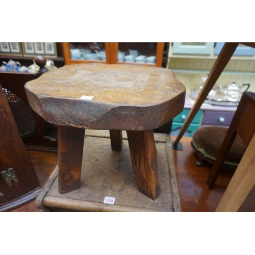 1159 - A 1920s oak tambour front filing cabinet, 108cm high x 44.5cm wide; together with an elm milking typ... 