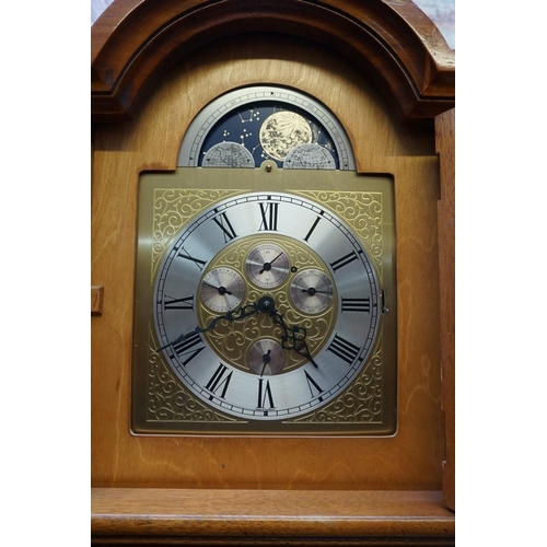 1172 - A reproduction yew longcase clock, striking on eight straight gongs, 195cm high, with pendulum ... 