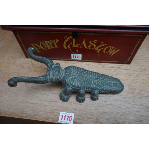 1176 - A painted metal casket, 35cm wide; together with a brass beetle doorstop, 26cm long.... 