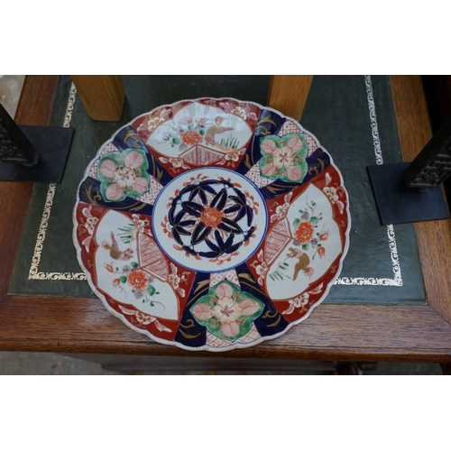 1204 - A pair of Japanese Imari charges, 31cm diameter.