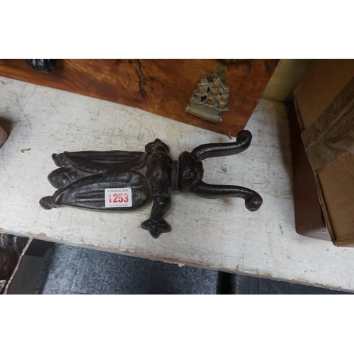 1253 - A cast iron beetle doorstop; together with another marble doorstop, each 26cm long. ... 