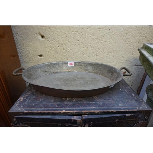 1263 - A set of four copper twin handled oval pans, 46cm wide.