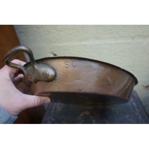 1263 - A set of four copper twin handled oval pans, 46cm wide.