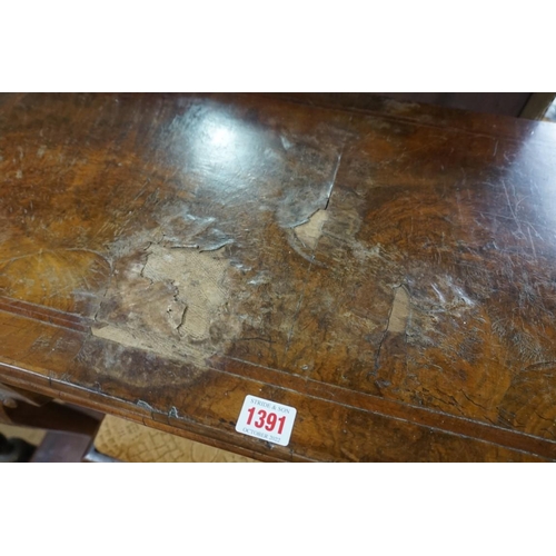 1391 - A 18th century figured walnut card table, with outset corners, on cabriole legs with ball and claw f... 