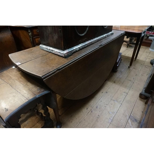 1398 - An 18th century oak gateleg table, on turned legs with pad feet, 154cm long.