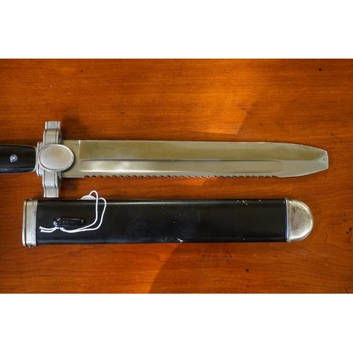 1798 -  A German Third Reich Red Cross 'Hewer' dagger and sheath, the 26.5cm saw back blade inscribed 'Ges.... 