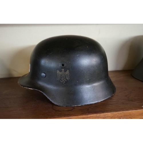 1806 - A German Third Reich M35 pattern steel helmet, bearing two decals, with liner.