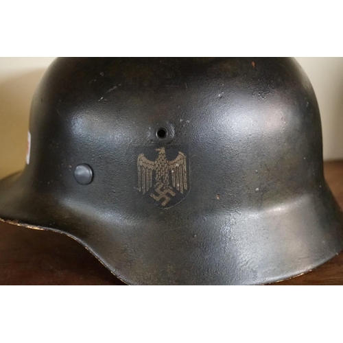 1806 - A German Third Reich M35 pattern steel helmet, bearing two decals, with liner.