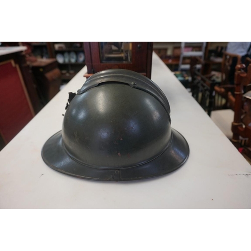 1808 - An interesting Italian World War I Adrian steel helmet, with liner and strap, combat bullet entry an... 