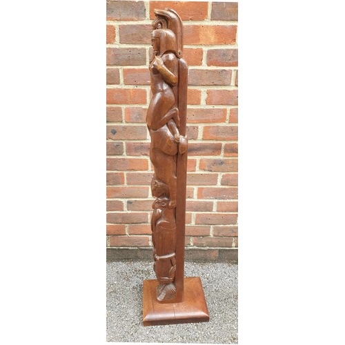 1077 - An unusual carved walnut totem pole, decorated with Egyptian figures, 117cm high.