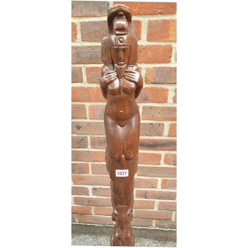 1077 - An unusual carved walnut totem pole, decorated with Egyptian figures, 117cm high.