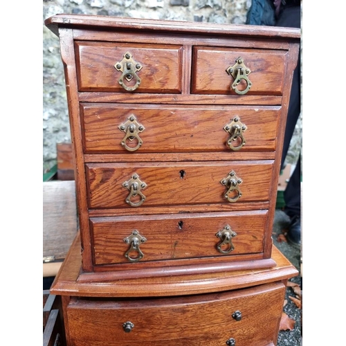 1013 - Three miniature chests of drawers; together with a small smokers chest and trays.