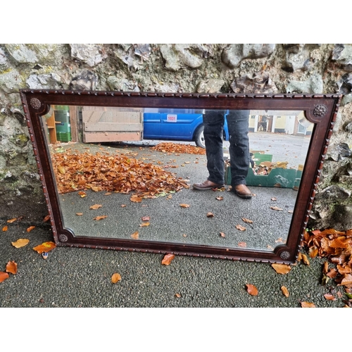 1031 - A carved mahogany and inlaid bevelled overmantel mirror, 100cm wide x 65cm high. ... 