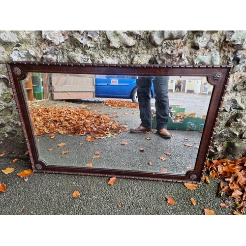 1031 - A carved mahogany and inlaid bevelled overmantel mirror, 100cm wide x 65cm high. ... 