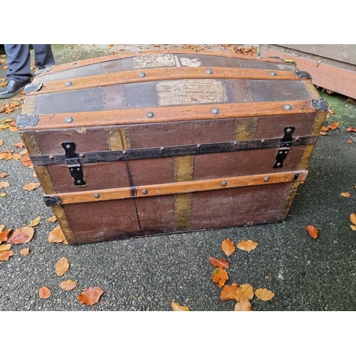 1038 - A vintage wood bound dome topped trunk. 