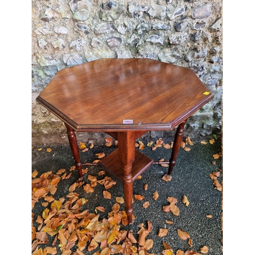 1053 - A mahogany hexagonal table, 74cm wide x 76cm high. 