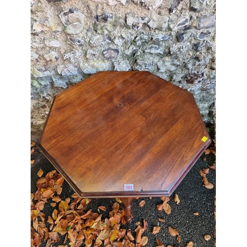 1053 - A mahogany hexagonal table, 74cm wide x 76cm high. 