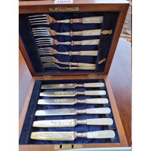 1058 - A cased set of six EPNS mother of pearl handled tea knives and forks; together with a small quantity... 