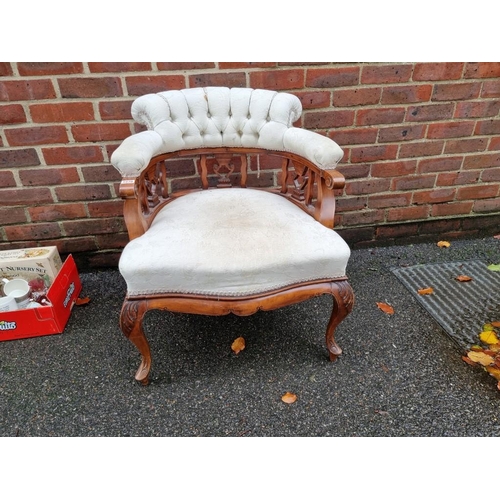 1070 - A late Victorian walnut and upholstered tub chair. 