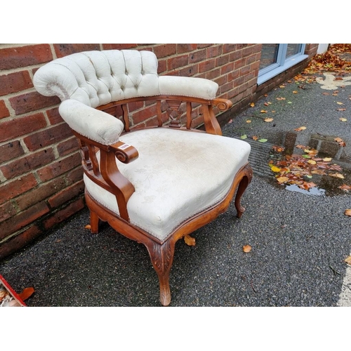 1070 - A late Victorian walnut and upholstered tub chair. 