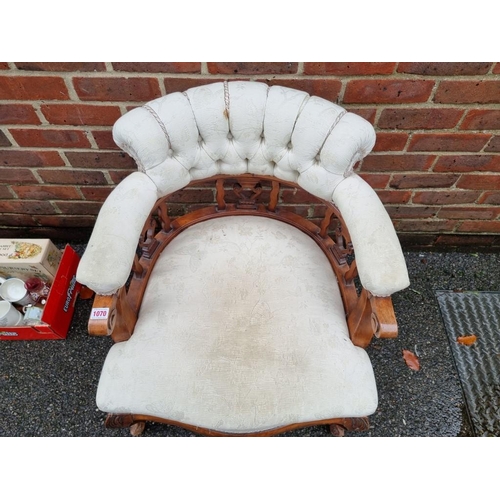 1070 - A late Victorian walnut and upholstered tub chair. 