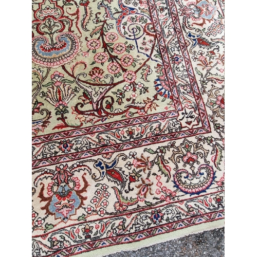 1079 - A large Persian carpet, having large central medallion, with floral central field on a green ground,... 