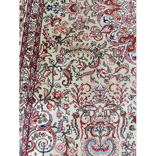 1079 - A large Persian carpet, having large central medallion, with floral central field on a green ground,... 