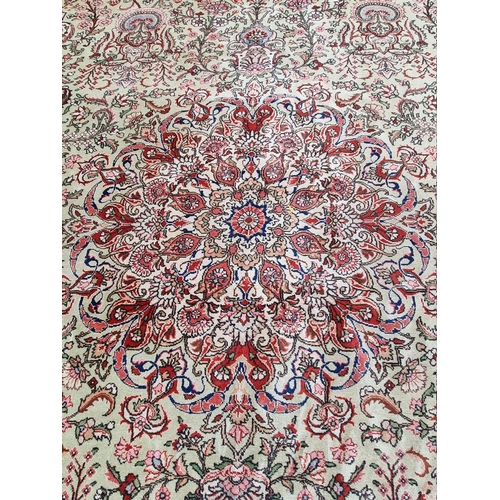 1079 - A large Persian carpet, having large central medallion, with floral central field on a green ground,... 