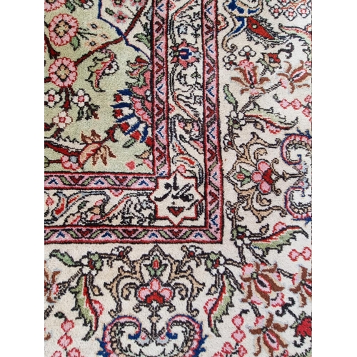 1079 - A large Persian carpet, having large central medallion, with floral central field on a green ground,... 