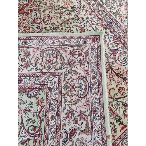 1079 - A large Persian carpet, having large central medallion, with floral central field on a green ground,... 