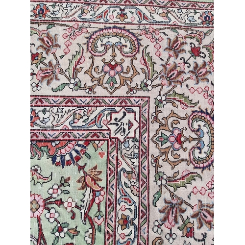 1079 - A large Persian carpet, having large central medallion, with floral central field on a green ground,... 