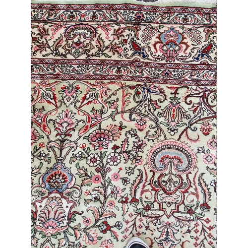 1079 - A large Persian carpet, having large central medallion, with floral central field on a green ground,... 