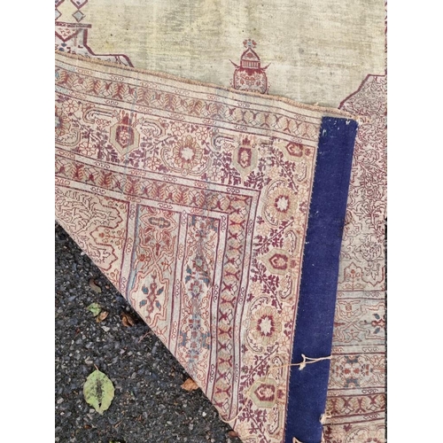 1091 - A Kashmiri silk rug, having temple design to central field, with heads to one end, with floral ... 