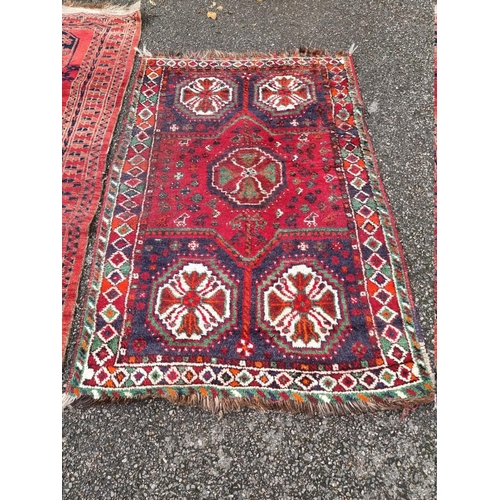 1097 - A Persian rug, having four central medallions, on a red ground, 201 x 94cm; together with another ru... 