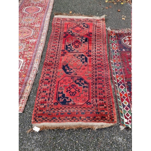 1097 - A Persian rug, having four central medallions, on a red ground, 201 x 94cm; together with another ru... 