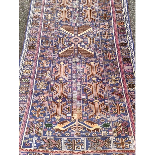 1098 - A Persian rug, having allover geometric design with floral borders, 206 x 106cm. ... 