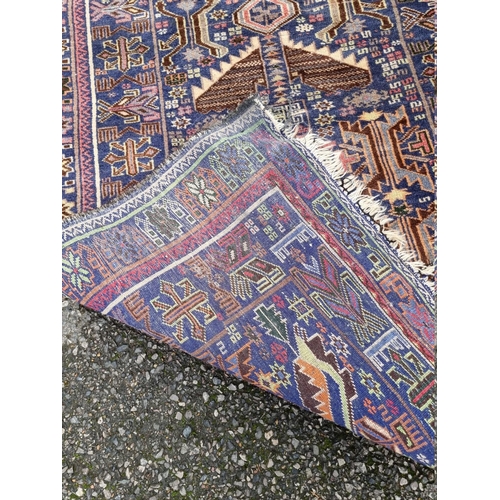 1098 - A Persian rug, having allover geometric design with floral borders, 206 x 106cm. ... 