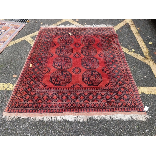 1099 - A Persian rug, having allover geometric field, 180 x 122cm; together with a Bokhara rug, 1... 