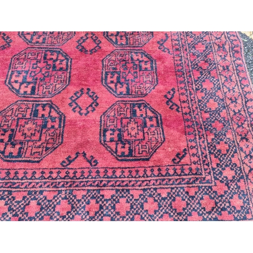 1099 - A Persian rug, having allover geometric field, 180 x 122cm; together with a Bokhara rug, 1... 