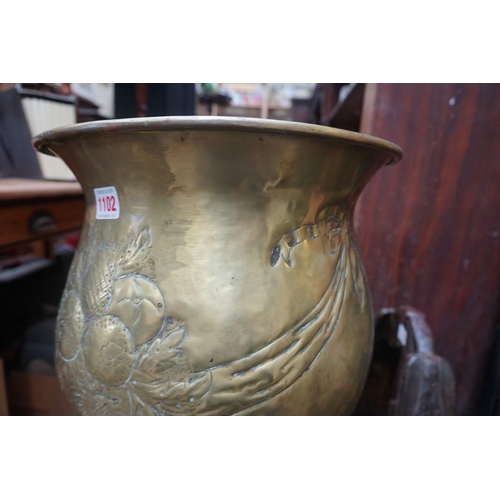 1102 - An old embossed brass pedestal jardiniere, 83.5cm high; together with a brass watering can. (2)... 