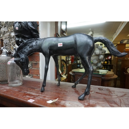 1108 - A black painted metal horse, 69cm long.